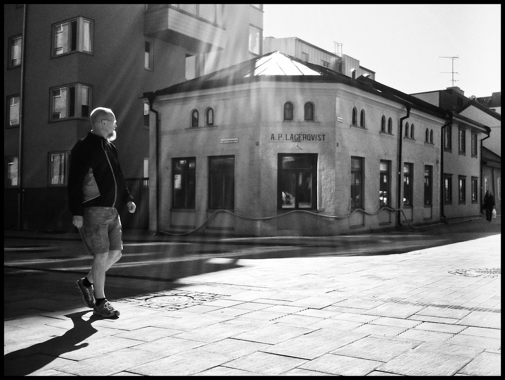 Man with bear and shorts walking, Uppsala, Sweden