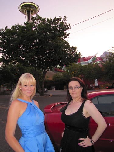 two elegant women, a red car and the space needle