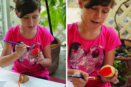 applying paint to potato stamp for Rosh Hashanah craft