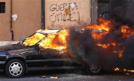 A burning car during the World Day of Occupation in Rome. The anti-capitalist movement is spreading from the United States to Italy. by Pan-African News Wire File Photos