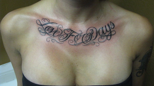 Tattoo on chest that reads love for days in cursive Photo by creepstattoo