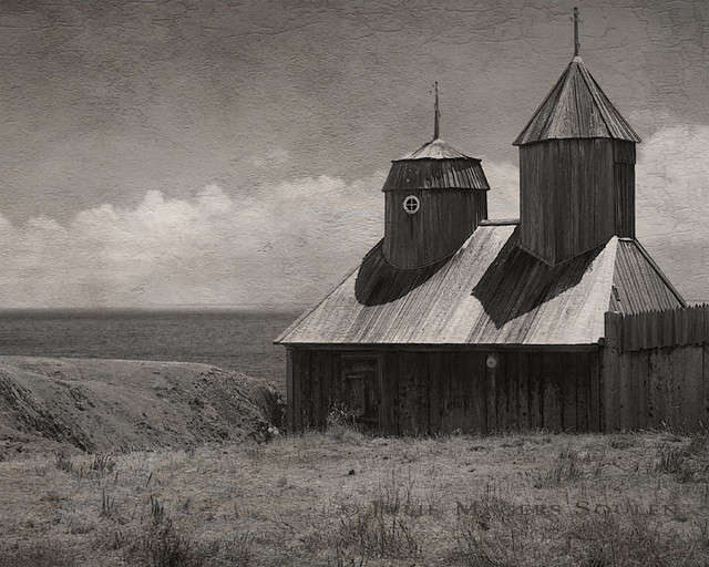 a textured and aged sepia photograph of Fort Ross, California