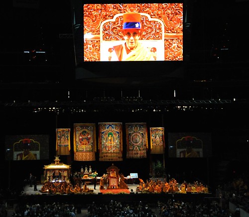 His Holiness the Dalai Lama wearing the Uncle Sam American hat given to him by a disciple, on stage with monks and nuns, large thangkas of Buddha, Kalachakra, Padmasambhava, mandala, White Tara, Kalachakra for World Peace, Verizon Center, Washington D.C., by Wonderlane