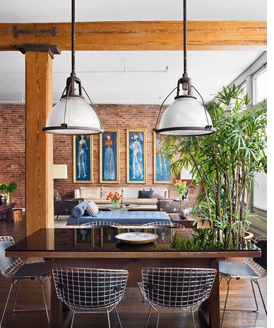 stephan jaklitsch loft exposed brick dining room area dome pendant lights Bertoia chairs wood table exposed brick