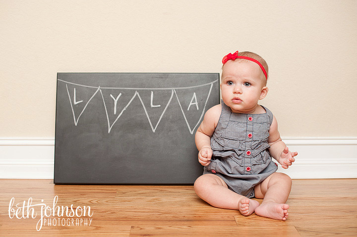 baby girl with her name by a chalkboard