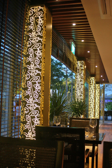 Modern ethnic art lights up the columns in the restaurant at night