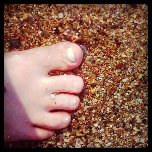 Toes in sand and surf