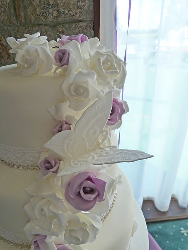3 tier vintage style wedding cake in a white purple silver theme