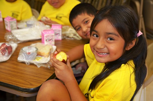 A youngster enjoys a crisp apple for lunch at the Puerto Rican Association for Human Development’s Mi Escuelita summer food program site in Perth Amboy, New Jersey.   More than 75 kids enjoy physical activities such as soccer and basketball followed by a free healthy lunch each day during summer thanks to the USDA Summer Food Service Program.