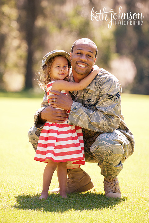 air force dad with his three year old daughter in red and white dress