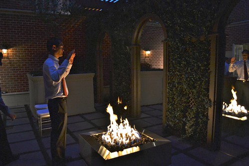 Chris in the firelit courtyard
