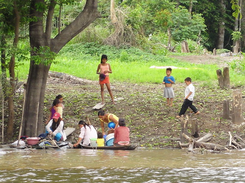 Family washing clothes in the river