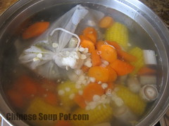 [photo-soup cooking with fish in muslin bag]