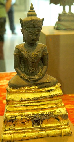 Cambodian Buddha or Bodhisattva in a tranquil meditation pose, on a gold lotus base, wearing a lotus hat, and ornamented robes, San Francisco International Airport, San Francisco, California, USA by Wonderlane