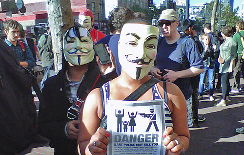 Masked protesters at the Civic Center station, BART protest