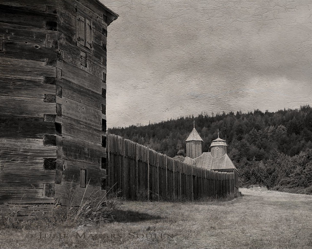 This is a textured and aged sepia photograph of Fort Ross.