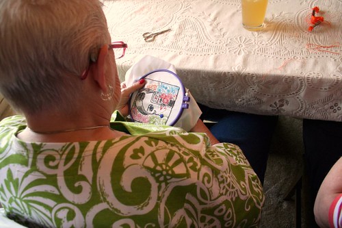 Granny embroidering twiggy look-a-like with a camera <3