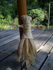 Corn husk doll with braided arms