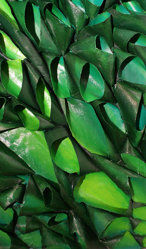 detail of sculptural bas relief  pod painting in various shades of green. Made of recycled cardboard tubes and acrylic paint.