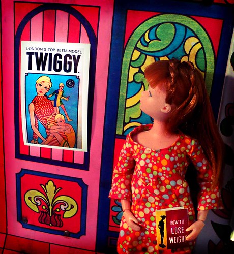 Unhappy with her looks, a redhead Dollikin doll looks to modeling sensation Twiggy for "thinspiration."
