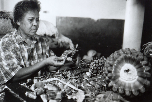 Tongan Woman making a lei