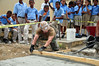 Navy Seabee smoothes and levels wet cement.