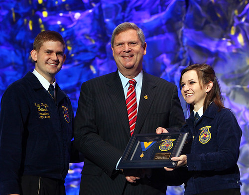 National FFA President Riley Pagett (left) and National FFA Vice President Shannon Norris (right)  present Secretary Vilsack with the Honorary American FFA Degree. This is the highest honor that the National FFA can bestow to supporters of Agricultural Education and FFA.  Photo courtesy FFA.