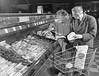People choosing choice cuts of meat at Bergs Supermarket, circa 1950