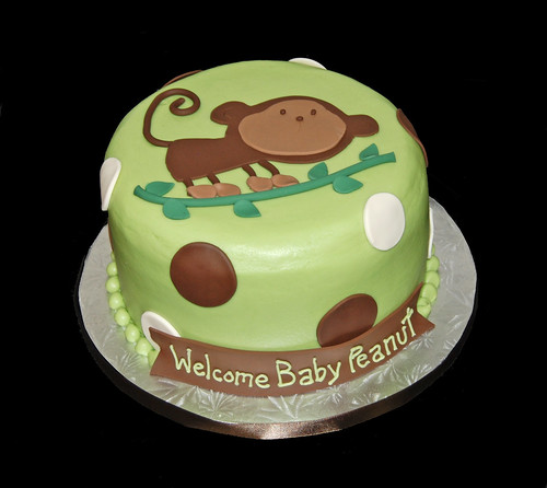 green and brown baby monkey on a branch baby shower cake