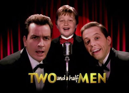 cast of two and a half men--two white men and a white boy singing into a microphone