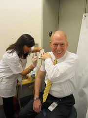 Tom gets his flu shot from a CVS pharmacist