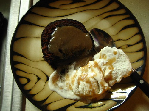 black chocolate party cake with vanilla ice cream and rum sauce