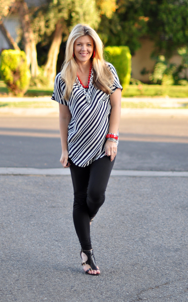 black and white diagonal striped blouse with red accessories