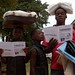Children read cholera-prevention leaflets
