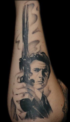 Black Ink Clint Eastwood With Gun Tattoo Design For Sleeve