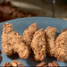 A strip of tender chicken breast is marinated in oil, dipped in a light tempura batter and rolled in a blend of pecans and Japanese bread crumbs.