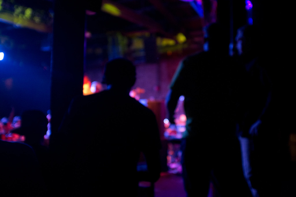 Out-of-focus crowd silhouette bathed in electric blue and magenta stage lighting at Brooklyn Bowl.