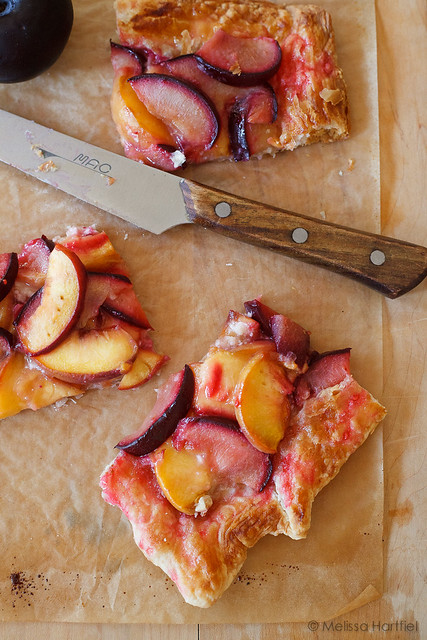three slices of a peach plum tart waiting to be eaten
