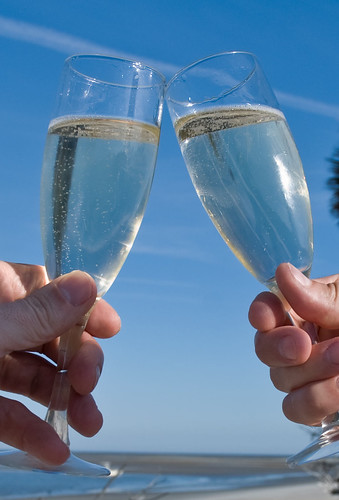 Champagne glasses, toasting at the beach
