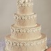 Beautiful white decorations on dusty peach icing make this cake fit for a princess.