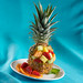 Whole pineapple with top cut off.  The pineapple is scooped and then filled with fresh fruit.  The top is then replaced.