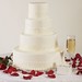 The true definition of classic!  This four tier cake is covered in a smooth fondant.  Each tier is accented with fondant ribbon embossed with scrolls and highlighted with a pearl shimmer.