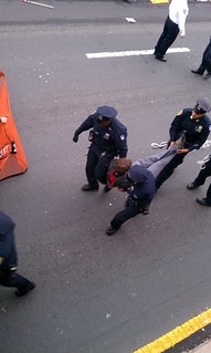 Police carry protester