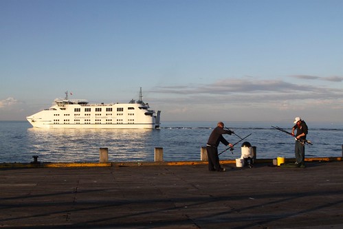 The car ferry passes fishermen packing up